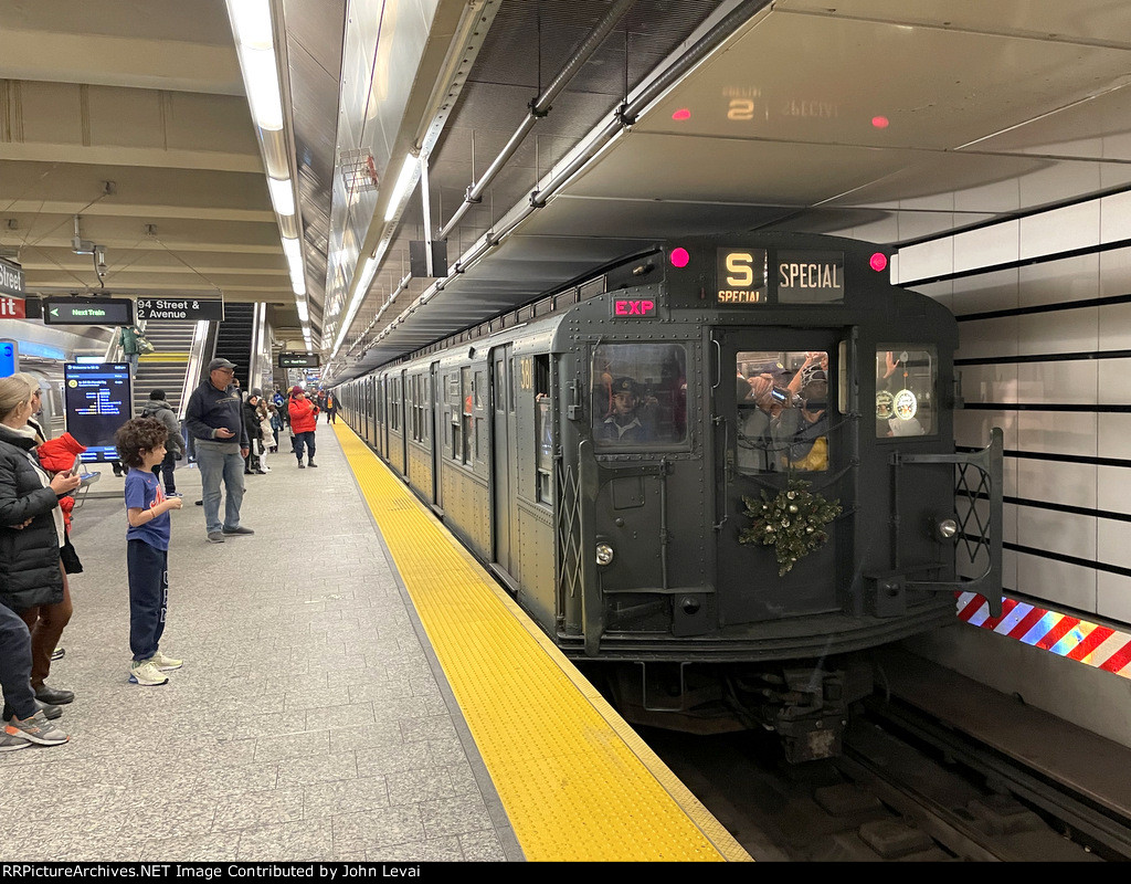 A midday holiday train is awaiting its departure from 96th St Station 